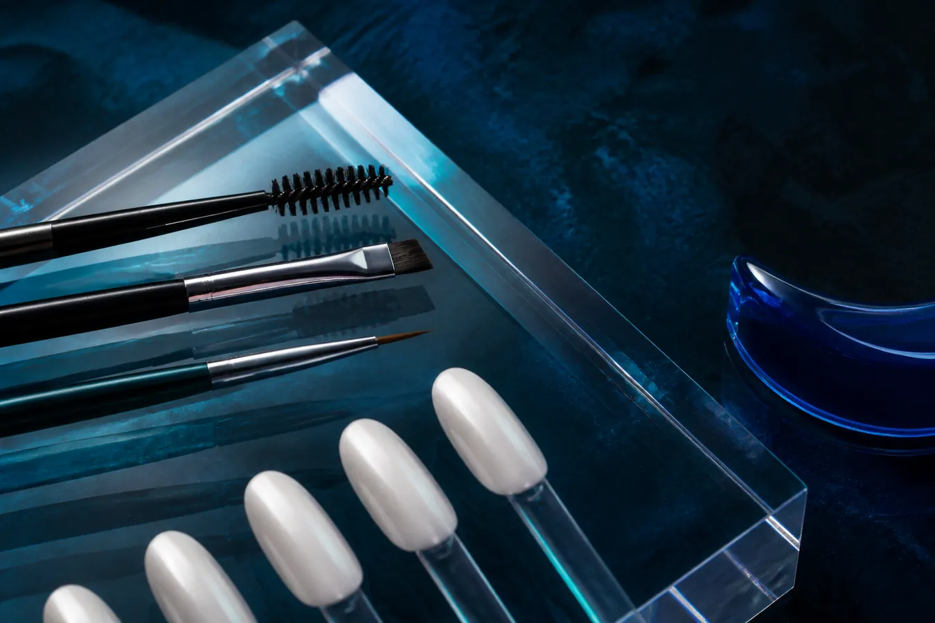 Editorial arrangement of lash, brow and nail artistry tools